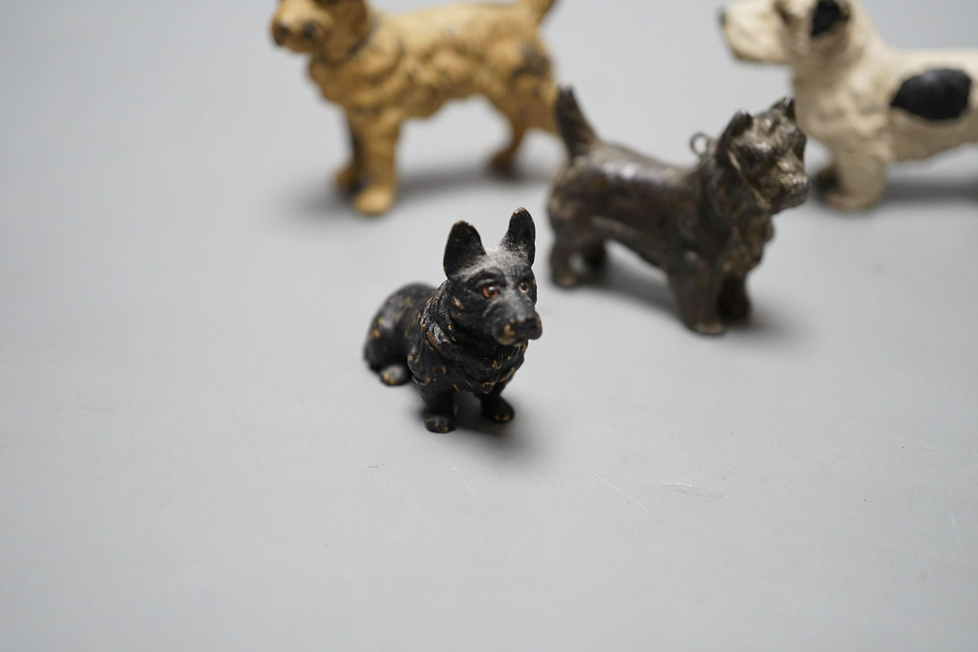 Four cold painted dogs, two bronze, tallest 5.5cm